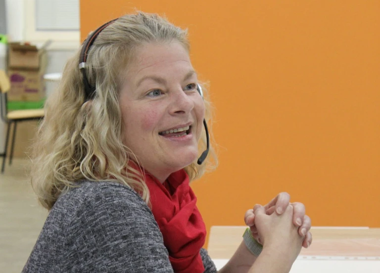 Domestic Abuse and Safeguarding Coordinator Gina, at her desk in the office