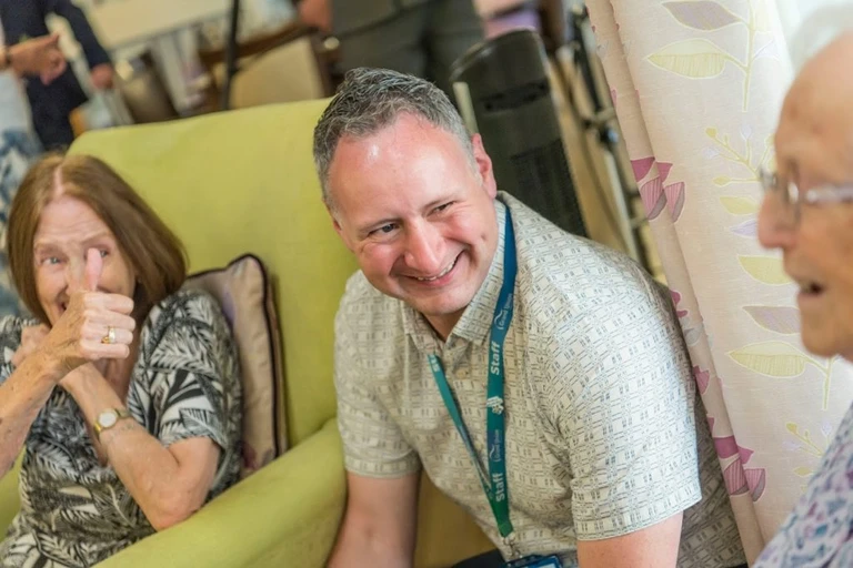 Mark, Life24 and Visiting Manager, with female residents at Flowers House, Bletchley