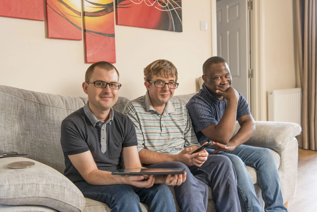 Robert, Daniel and Frank sat on the sofa in their supported living home