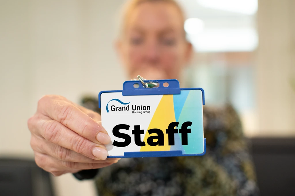 Grand Union colleague holding up their staff badge