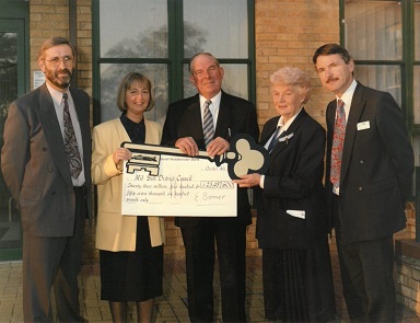 Colleagues from Mid Beds Housing Association handing a cheque for £23,457,600 to Mid Beds District Council. 