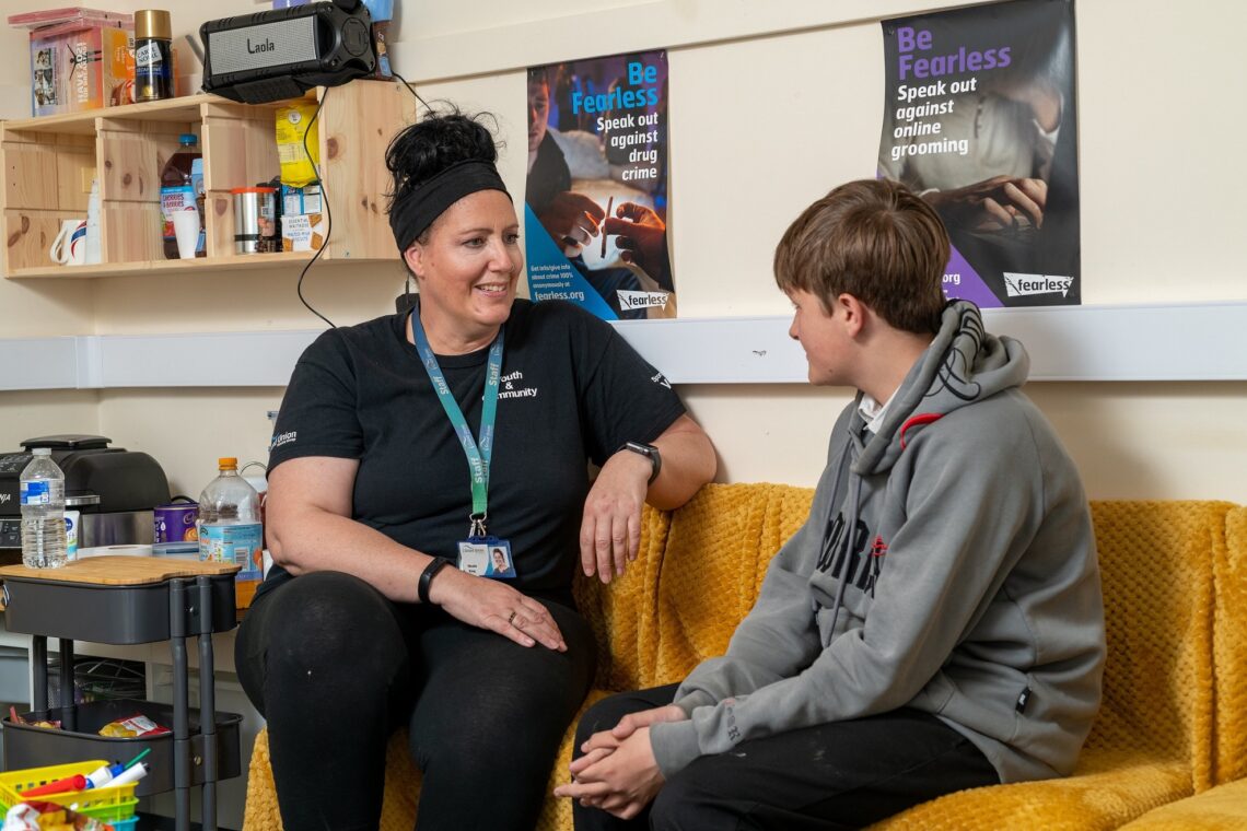 Nicola King talking to a young person at the youth hub