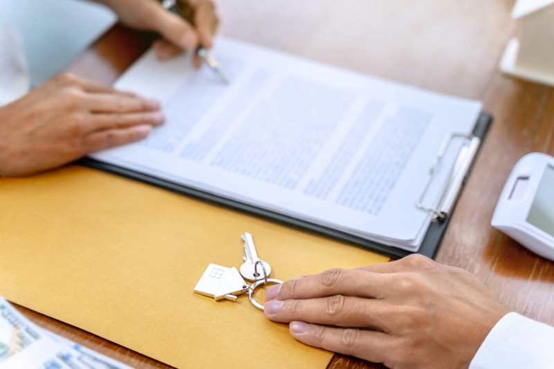 tenancy changes, a hand signing a tenancy agreement.