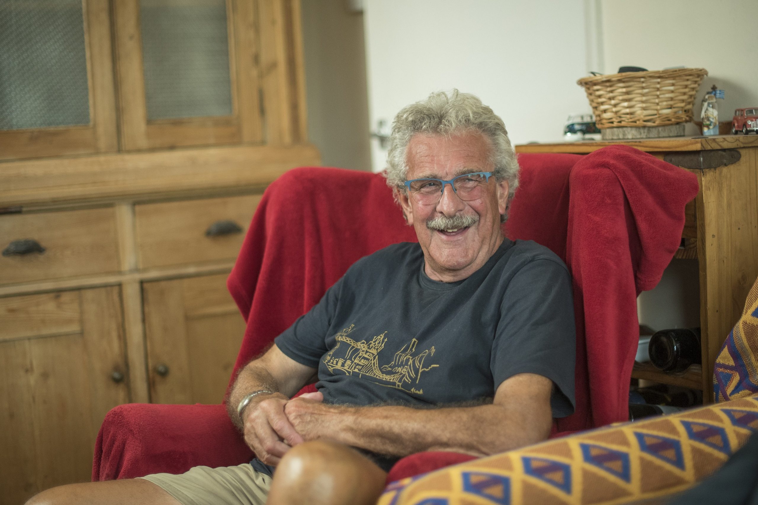 Peter sitting in his armchair, smiling